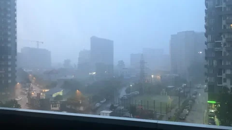 Rain falling over Batumi high-rise district in elevated city view Stock Footage 345361636