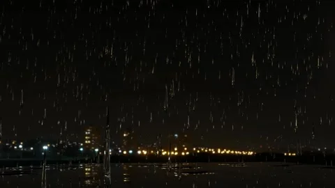 Rain falling over the city at night forming puddles. Stock Footage 206796861