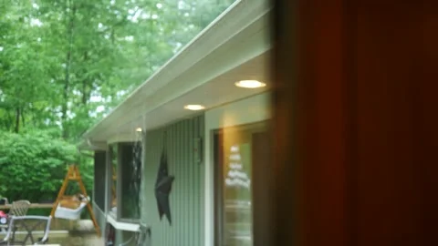 Rain Falling over Full Gutter in Ranch Style House Stock Footage 335663225