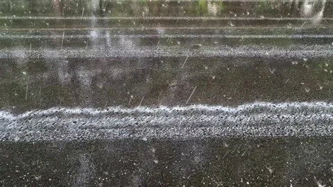 Rain falling on a paved road Stock Footage 283097958