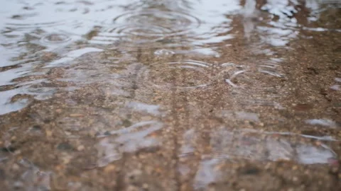 Rain Falling in Puddle on Flooded Street Video Stock Footage 343892514