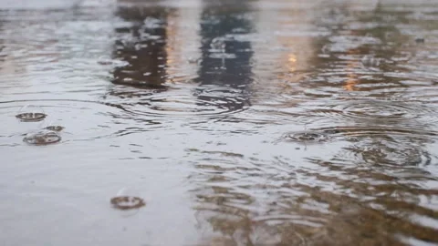 Rain Falling in Puddle on Flooded Street Video Stock Footage 343892645