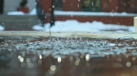 Rain falling on a puddle Stock Footage 47463365