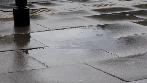 Rain falling on a puddle with the reflection of cars passing by Stock Footage 196209763