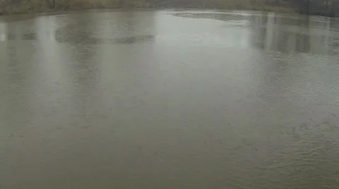 Rain falling on a river on a grey day Stock Footage 33683530