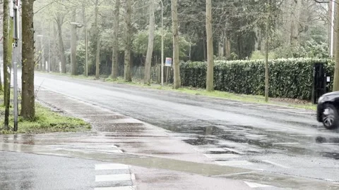 Rain falling on road creating difficulties for traffic passing by Stock Footage 274319980
