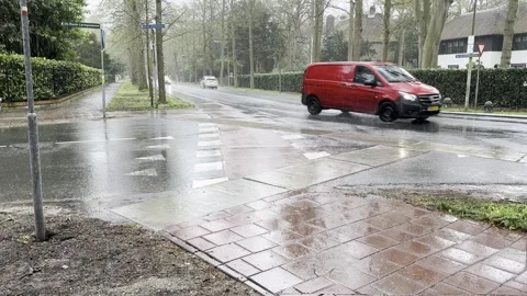 Rain falling on road creating difficulties for traffic passing by Stock Footage 291766171
