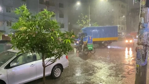 Rain falling on the road,  rainy day night view in the city Stock Footage 284728881
