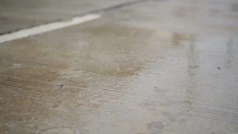 Rain falling on the road in slow motion. Stock-Footage 92457619