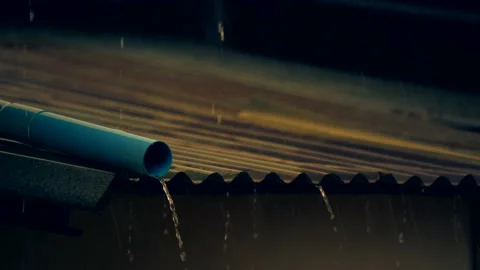 Rain falling on roof on dark background, heavy rainy droplet on fresh nature  Stock Footage 131868803