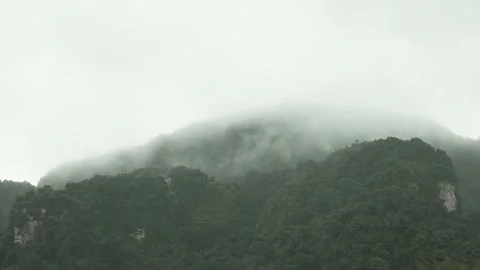 Rain Falling with slowly moving cloud and mist on sky covered mountain Stock Footage 153506266