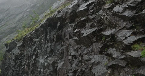 Rain falling on a steep rock wall in the norwegian mountains Stock-Footage 326353137