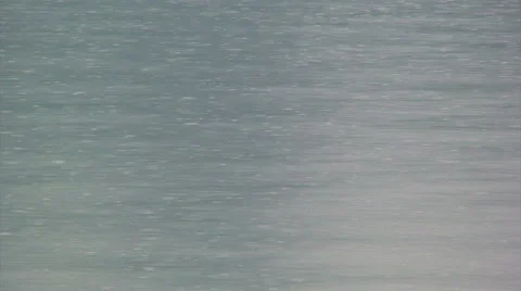 Rain falling on still lake surface Stock Footage 39986662