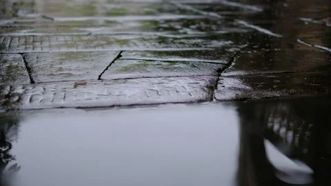 Rain falling on a stone paved road Stock Footage 149247341