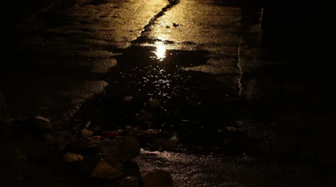 Rain falling on the street at night, close up shot Stock Footage 34406328