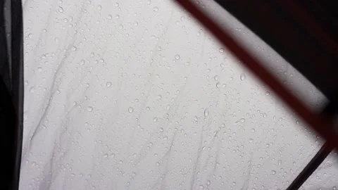 Rain falling on a tent captured from inside of the tent Video stock 235153065
