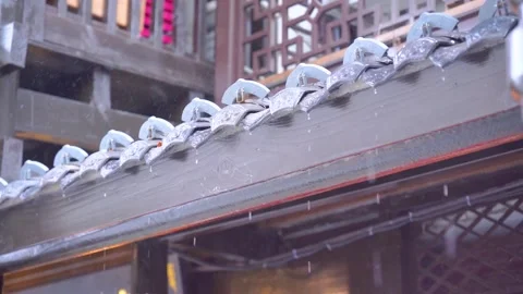 Rain falling on traditional wooden eaves of an ancient Chinese style building Stock Footage 341959869