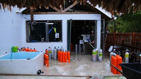 Rain falling at tropical scuba diving shop Stock Footage 87365506