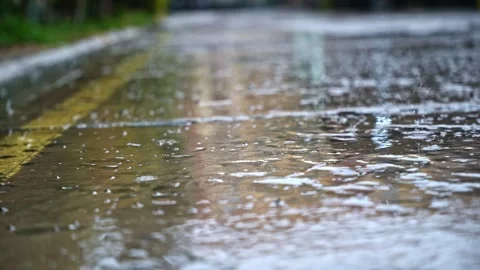 Rain Falling on Urban Pavement Close Up Stock Footage 346197569