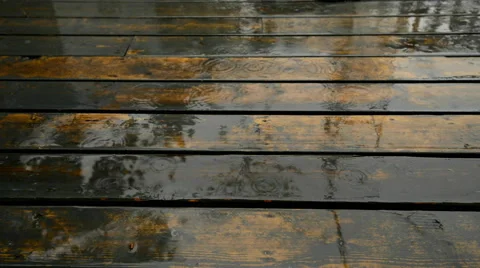 Rain falling on a weathered deck Stock Footage 51139888