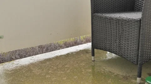 Rain Falling on Wet Balcony Patio with Wicker Chair, Berlin Stock-Footage 345040016