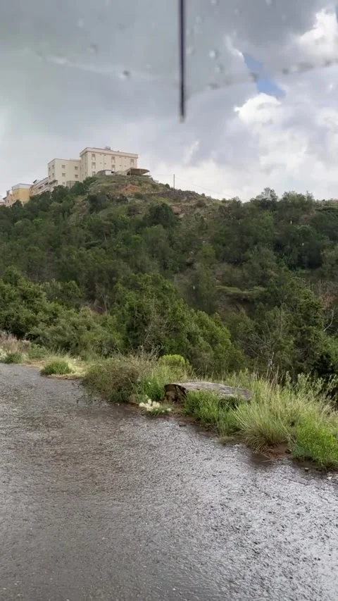 Rain Falling on Wet Road and Green Hillside 库存影片 342266533