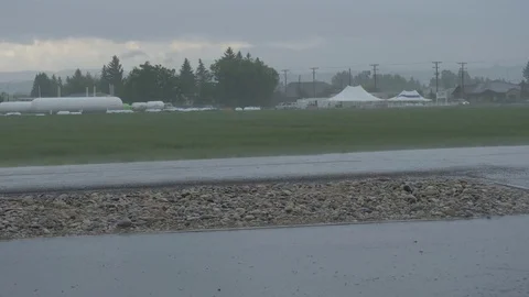 Rain falling on the wet road during a storm Stock Footage 76720277