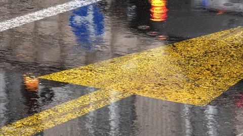Rain Falling on Wet Street With Blurred Car Reflections Video stock 346370338