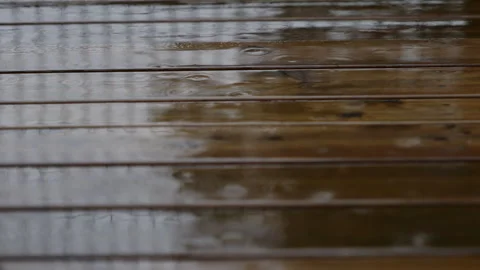 Rain falling on a wet wood deck during a storm Stock Footage 341782220