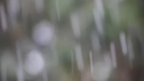 Rain falling on window with blurred outdoor scene Fotos Stock