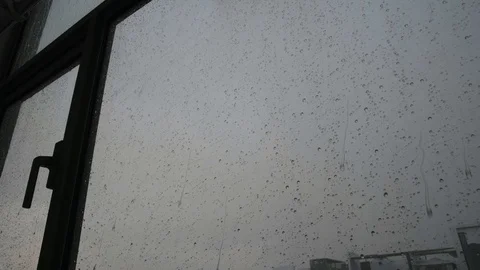 Rain falling on window Stock Footage