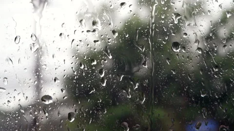 Rain Falling on Window Glass with Green Background Moody  Stock Footage 315049258