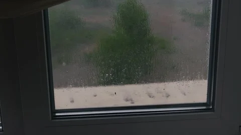 Rain Falling on Window Glass Pane with Blurry Green Nature Background Video stock 335234904