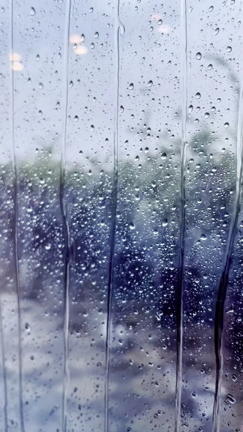 Rain Falling on Window Glass  Relaxing Moody Weather Scene with Water Droplet Stock-Footage 311695242