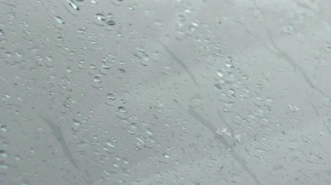 Rain falling on window glass,drops slide down car windshield,close up shot, Stock Footage 34450280