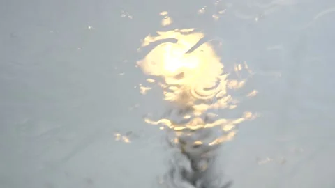 Rain falling on windshield window and rolling down glass Stock Footage 202380601