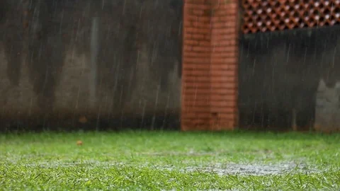 Rain falls and splashes on to the wet grass in Uganda, Africa Stock Footage 120553464