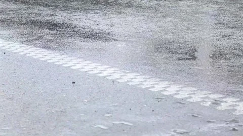 Rain falls on asphalt road surface with white dashed line Stock-Footage 308035768
