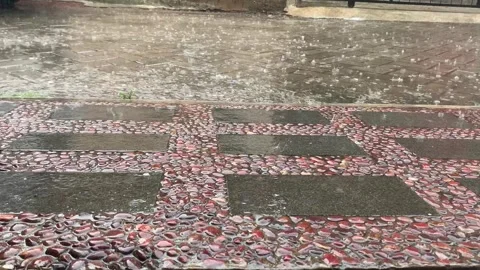 Rain falls on Colorful Geometric Pattern Textured Floor Stock Footage 260009231