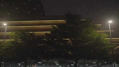 Rain falls on dark sky under modern building, beautiful lights Stock Footage 251974154