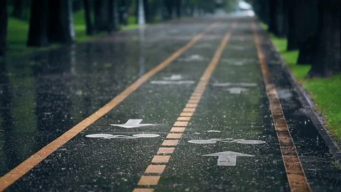 Rain falls down on a bicycle track in summer season Vídeo Stock 79066848