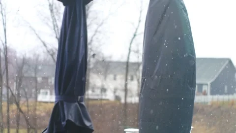 Rain falls gently in suburban backyard with covered furniture Video stock 302130004