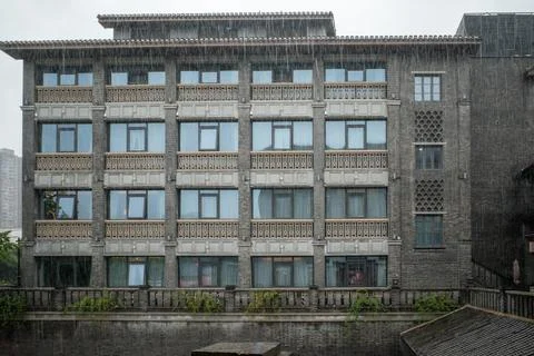 Rain falls gently on a weathered stone building Stock Photos