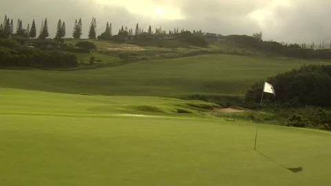 Rain falls onto golf course putting green Stock Footage 125340741