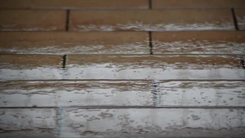 Rain falls on outdoor flooring, Full HD Stock Footage