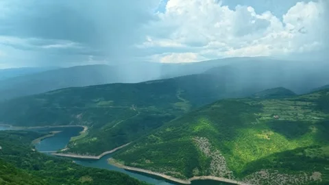 Rain falls over lush green mountains. Kozji Kamen viewpoint, Serbia 스톡 동영상 341875678