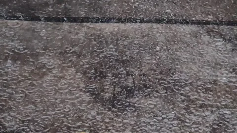 Rain falls on the road during the rainy season when vehicles travel 스톡 동영상 250474505