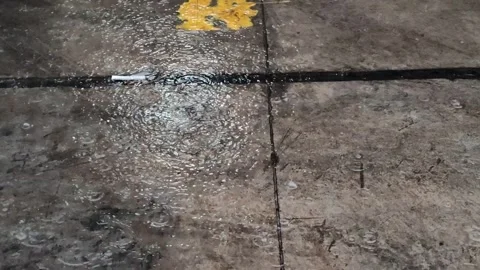 Rain falls on the road during the rainy season when vehicles travel 스톡 동영상 250474511