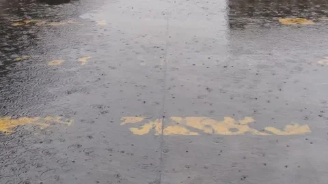 Rain falls on the road during the rainy season when vehicles travel 스톡 동영상 250474651