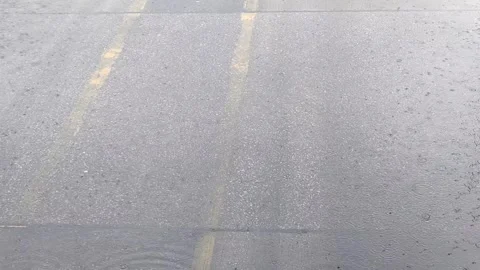 Rain falls on the road during the rainy season when vehicles travel 動画素材 250474663
